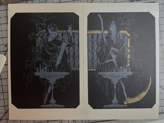 The final print. Two riso prints with white ink on black paper. The print on the left is a comic-style illustration of female knight holding a sword, sitting in front of the chess table. The print on the right is female death, holding a scythe, sitting in front of the chess table. Both prints are  set on one white paper.